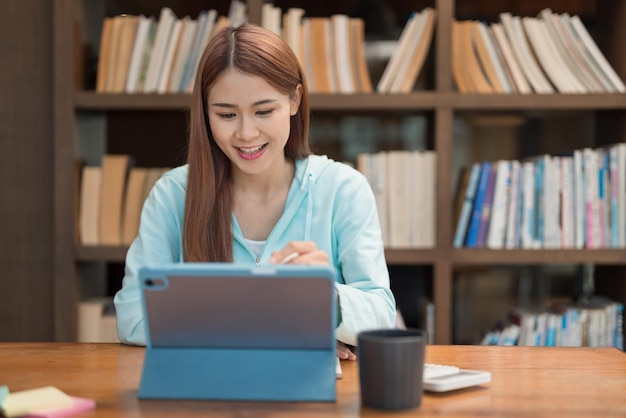 Education concept Teenage girl use tablet to surf social media to relaxation after study tutorial