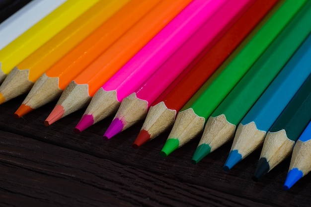 Education and creativity concept colored pencils on wooden background