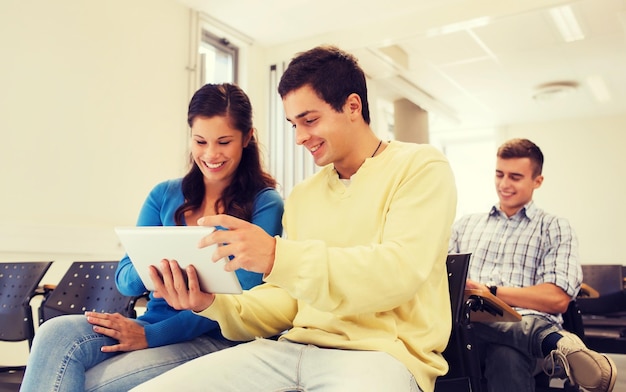 education, high school, teamwork and people concept - group of smiling students with tablet pc computers making photo or video in lecture hall