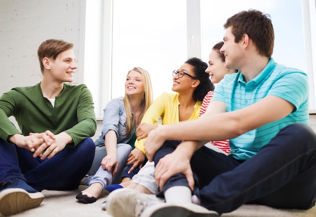 education, leisure and happiness concept - five smiling teenagers having fun at home