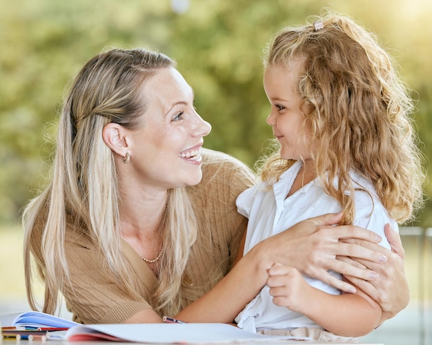 Education mother and child student writing school homework learning knowledge and lesson in a notebook Happy smile and proud math tutor helping and teaching her creative child in the family house