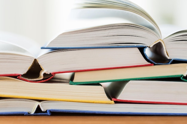 education, school, literature, reading and knowledge concept - close up of books on wooden table