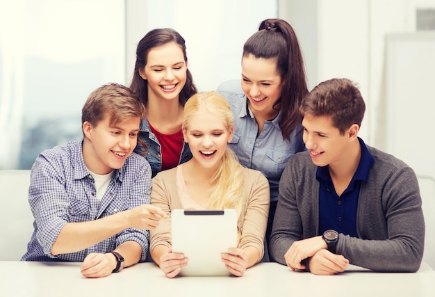 education, technology and internet concept - smiling students with tablet pc computer at school