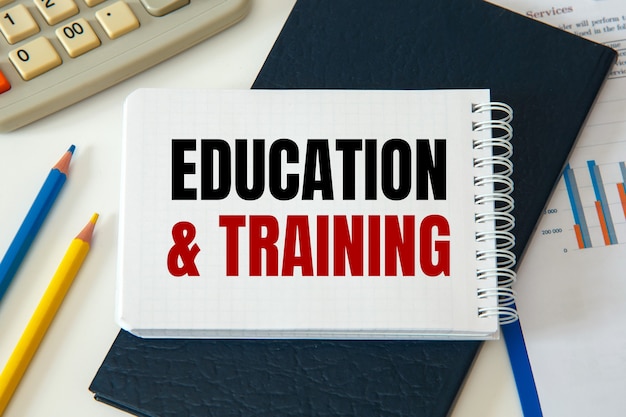 EDUCATION and TRAINING is written on a notepad, on an office desk with office accessories