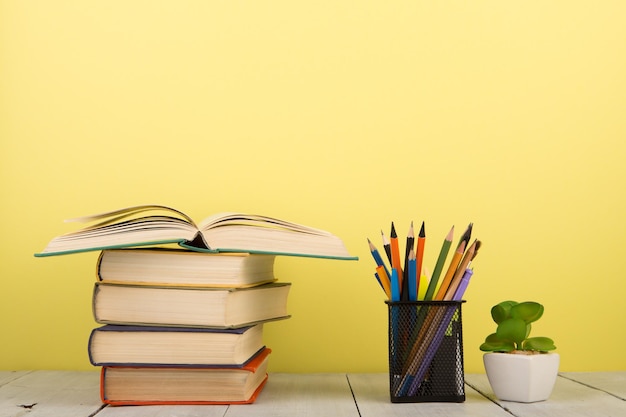 Education and wisdom concept open book on wooden table color background