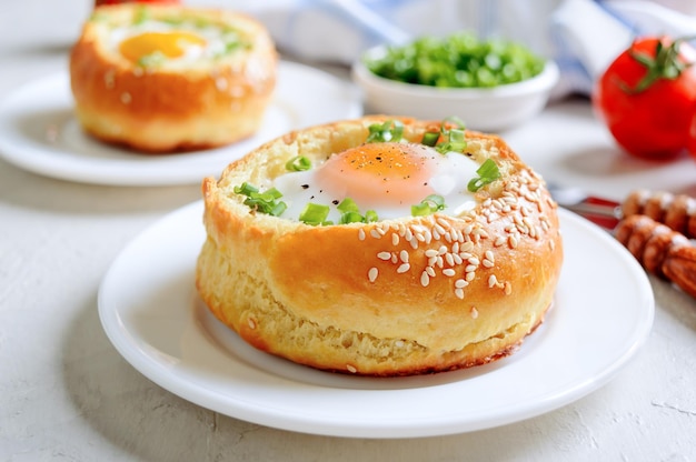 Egg baked in a soft bun with ham Delicious and quick breakfast