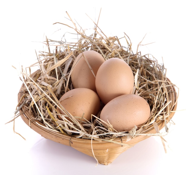 Egg,basket,straw on white background.