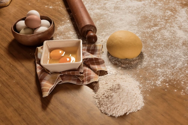 Egg dough for noodles with ingredients on the table traditional italian cuisine