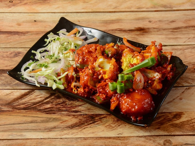 Egg manchurian served on rustic wooden background