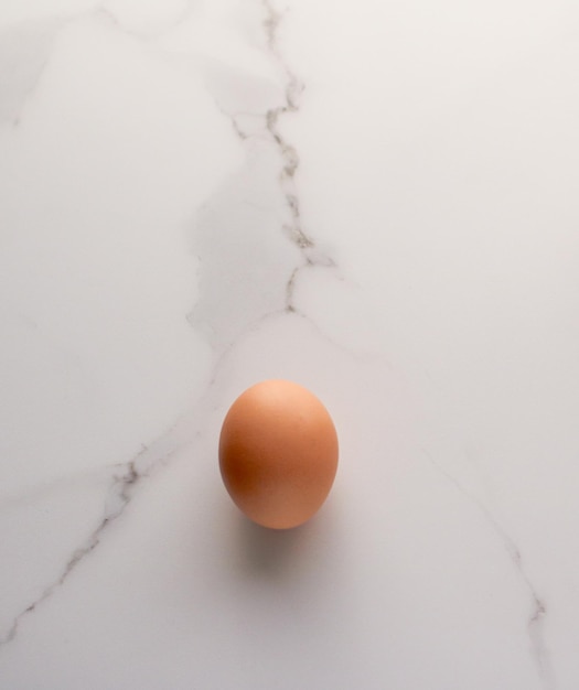 Egg on marble table as minimalistic food flat lay top view food brand photography flatlay and recipe inspiration for cooking blog menu or cookbook design