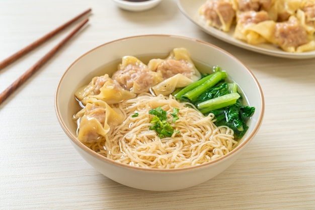 egg noodles with pork wonton soup or pork dumplings soup and vegetable - Asian food style