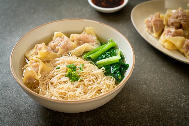 Egg noodles with pork wonton soup or pork dumplings soup and vegetable