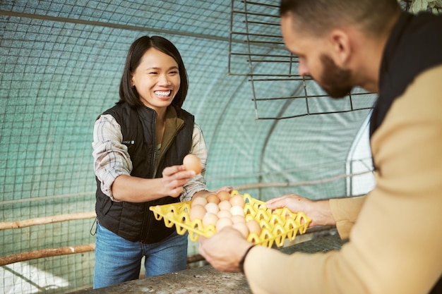 Egg production food business and Asian woman happy about eco friendly agriculture growth of eggs Chicken farmer sustainability and farming product check of a worker in a chicken coop with a smile