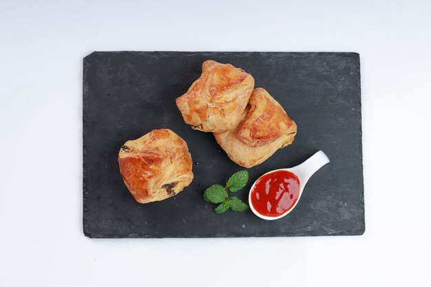 Egg Puff pastry filled with spicy and tasty egg masala and placed on graphite board