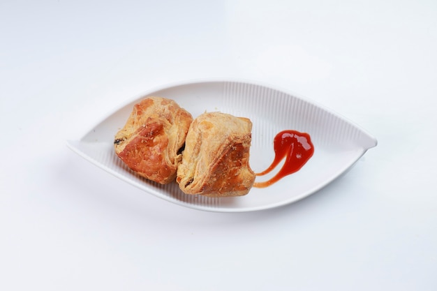 Egg Puff pastry filled with spicy and tasty egg masala and placed on a white tableware