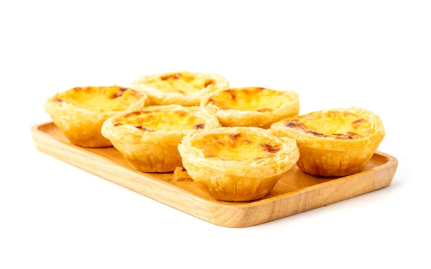 Egg tart the delicious crispy bekery on wooden plate isolated on white background