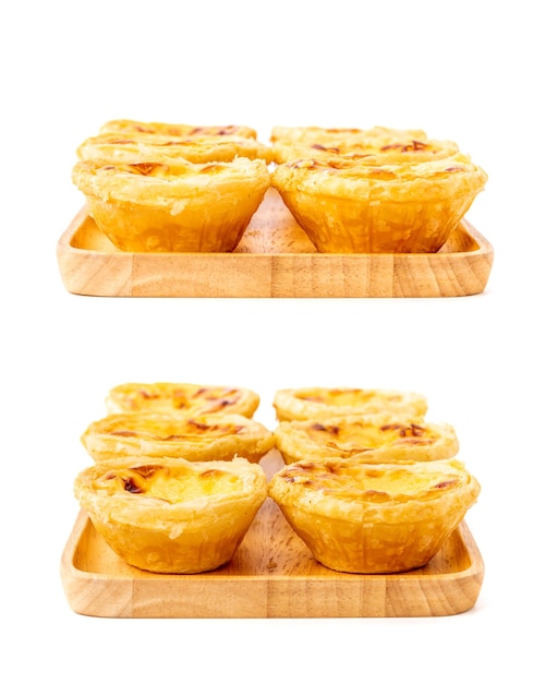 Egg tart the delicious crispy bekery on wooden plate isolated on white background