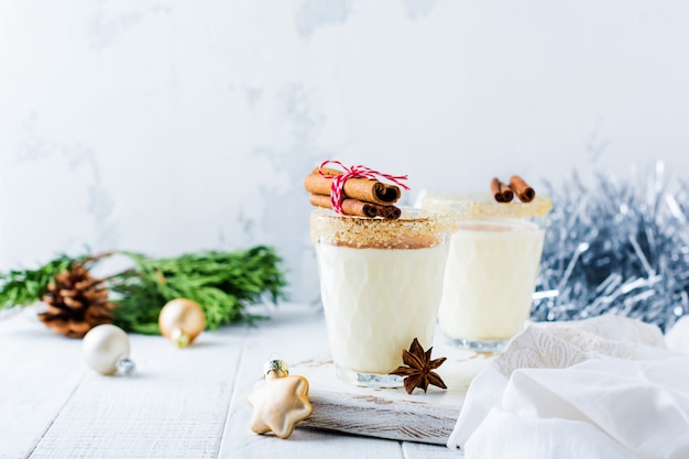 Eggnog Traditional Christmas drink milkshake with cinnamon old