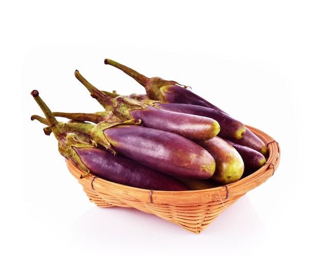 Eggplant in basket isolated on white.