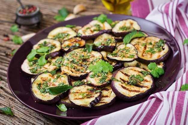 Eggplant grilled with balsamic sauce, garlic, cilantro and mint. Vegan food. Grilled aubergine.