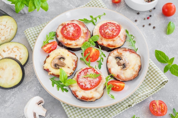 Eggplant pizza with tomatoes sauce mozzarella mushrooms and fresh basil Vegetarian dish