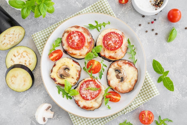 Eggplant pizza with tomatoes sauce mozzarella mushrooms and fresh basil Vegetarian dish