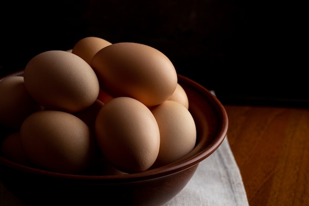 Eggs in a bowl on a wooden table