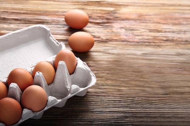 Eggs package on wooden background