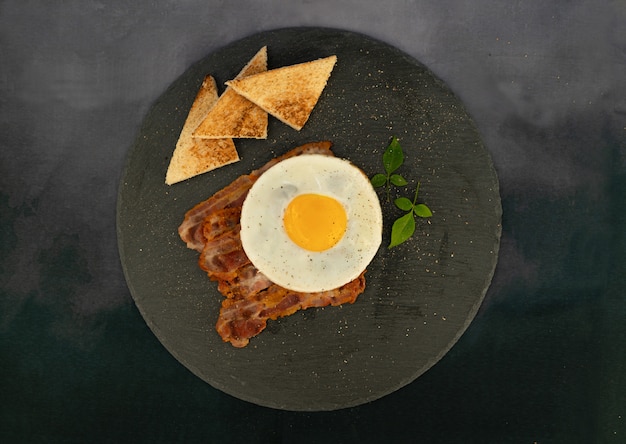 eggs with bacon and toast on the plate