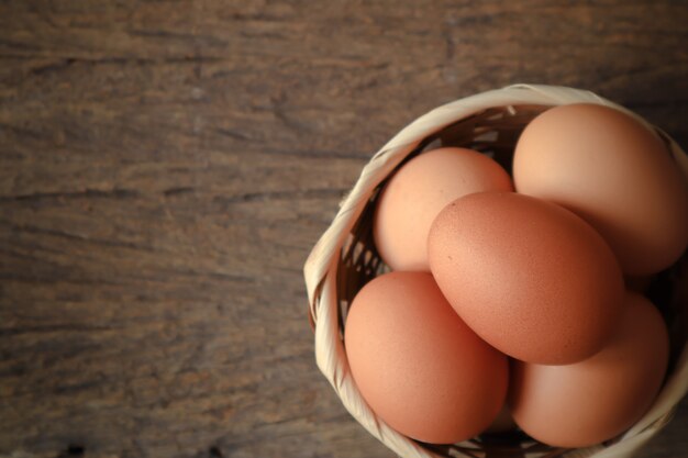 eggs in the wood basket on the wood table