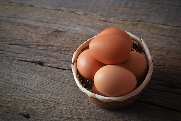 eggs in the wood basket on the wood table