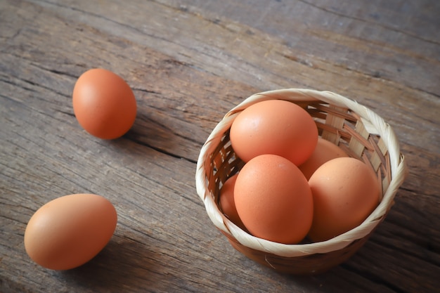 eggs in the wood basket on the wood table