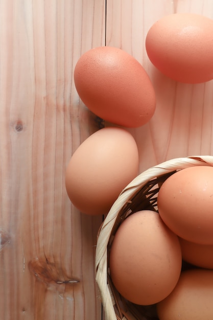 eggs in the wood basket on the wood table