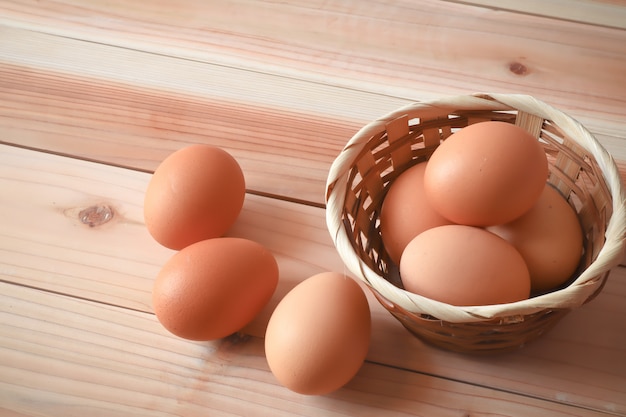 eggs in the wood basket on the wood table