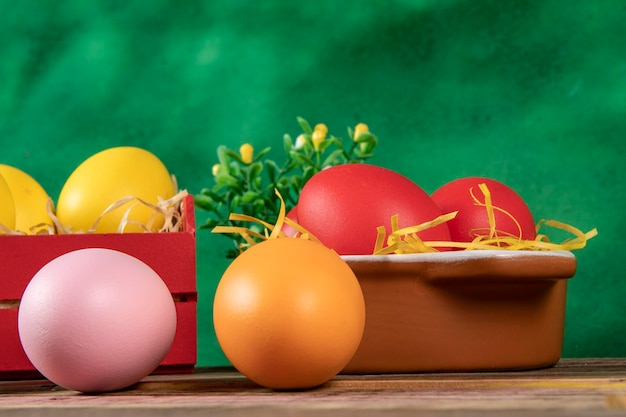 Eggs in wooden box with hay on rustic background or surface easter or holiday concept