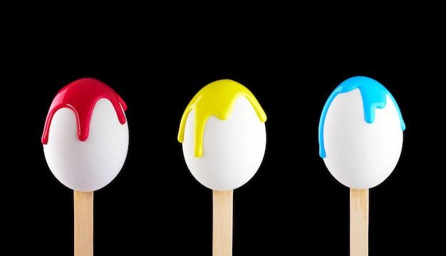 Eggs on a wooden stick doused with paint