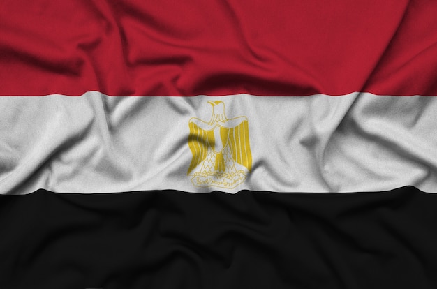 Egypt flag is depicted on a sports cloth fabric with many folds.