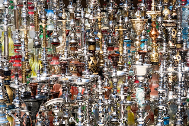 Egypt. Sale of hookahs in the eastern bazaar. Many different hookahs of large and small sizes made of glass on the market in Egypt