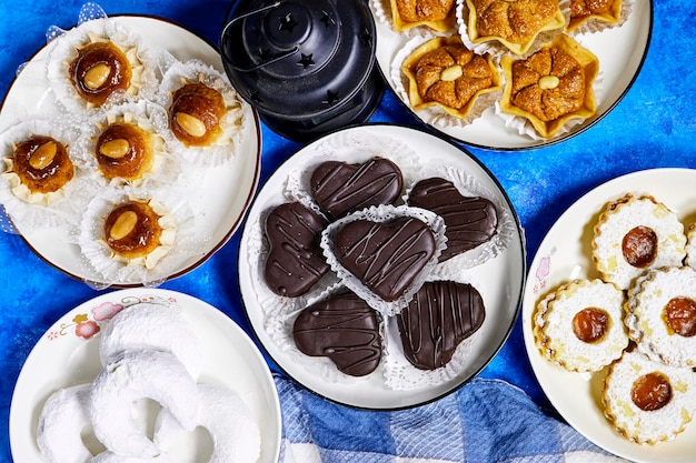 eid holiday table Oriental Algerian sweet cookies named dziriettes and kaab el ghazal