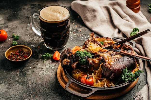 Eisbein with sauerkraut salad and beer. Oktoberfest menu, German cuisine.