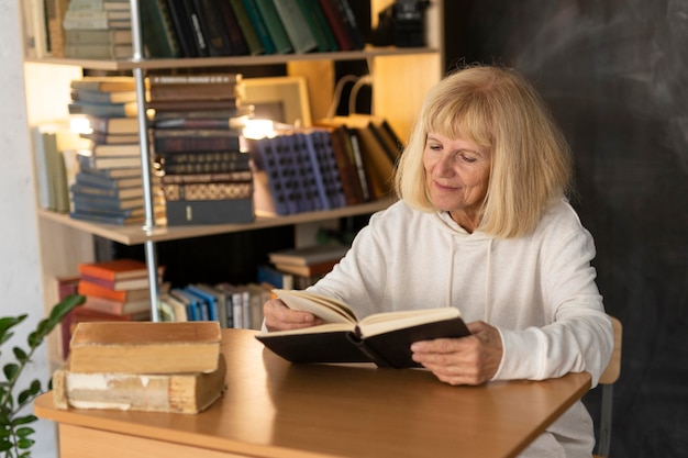 Elder woman reading a book at home