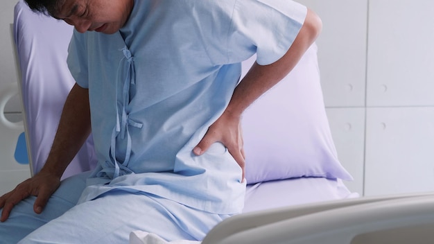 Elderly Asian male patient is hospitalized with back pain