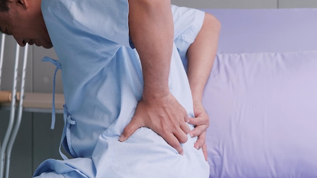 Elderly Asian male patient is hospitalized with back pain