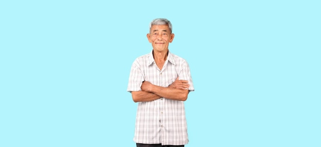 Elderly Asian man on blue background in studio With copy space