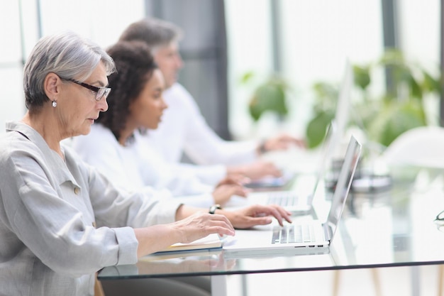 Elderly call center employee at the computer