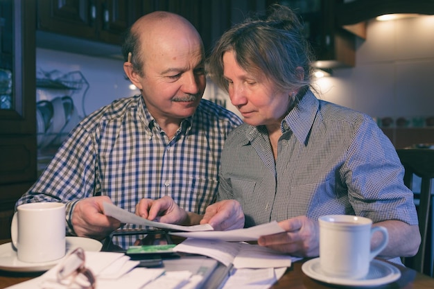 An elderly couple counting money and a budget