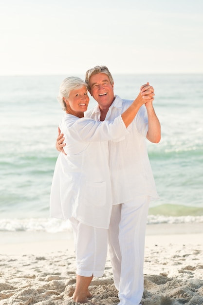 Elderly couple dancing on the beach