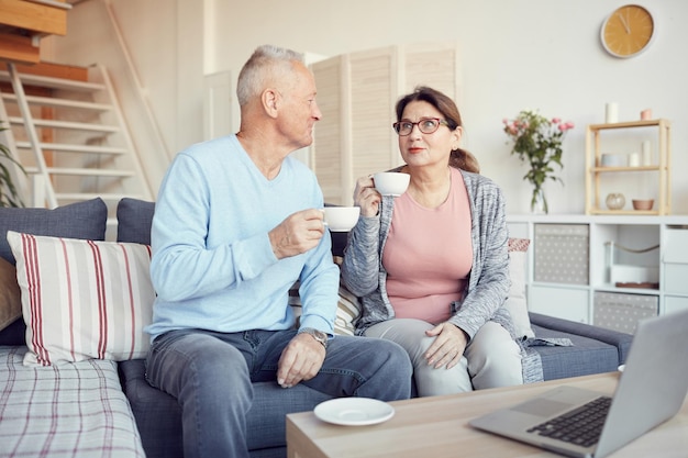 Elderly couple drinking tea at home