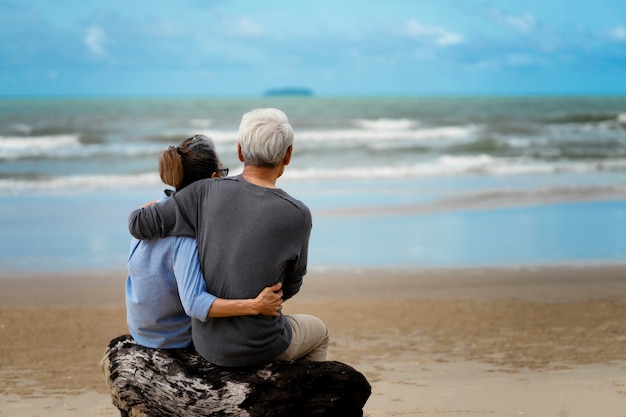 Elderly couple embraced at the seaside