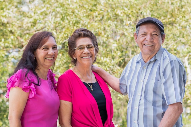 Elderly couple enjoying a day at the park with their daughter Active aging and family life